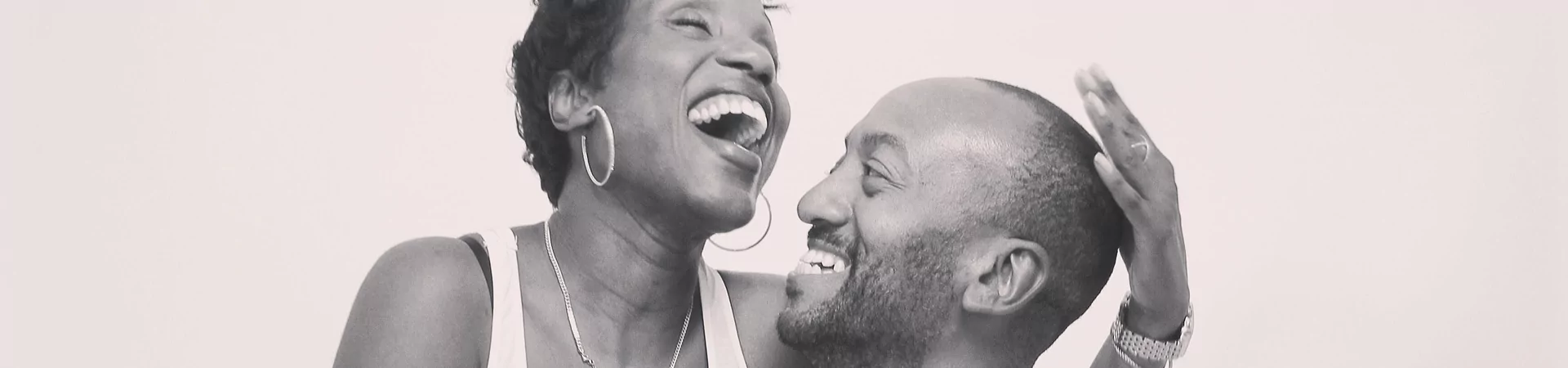 A monochrome photograph of a couple, capturing a moment of tenderness and connection.
